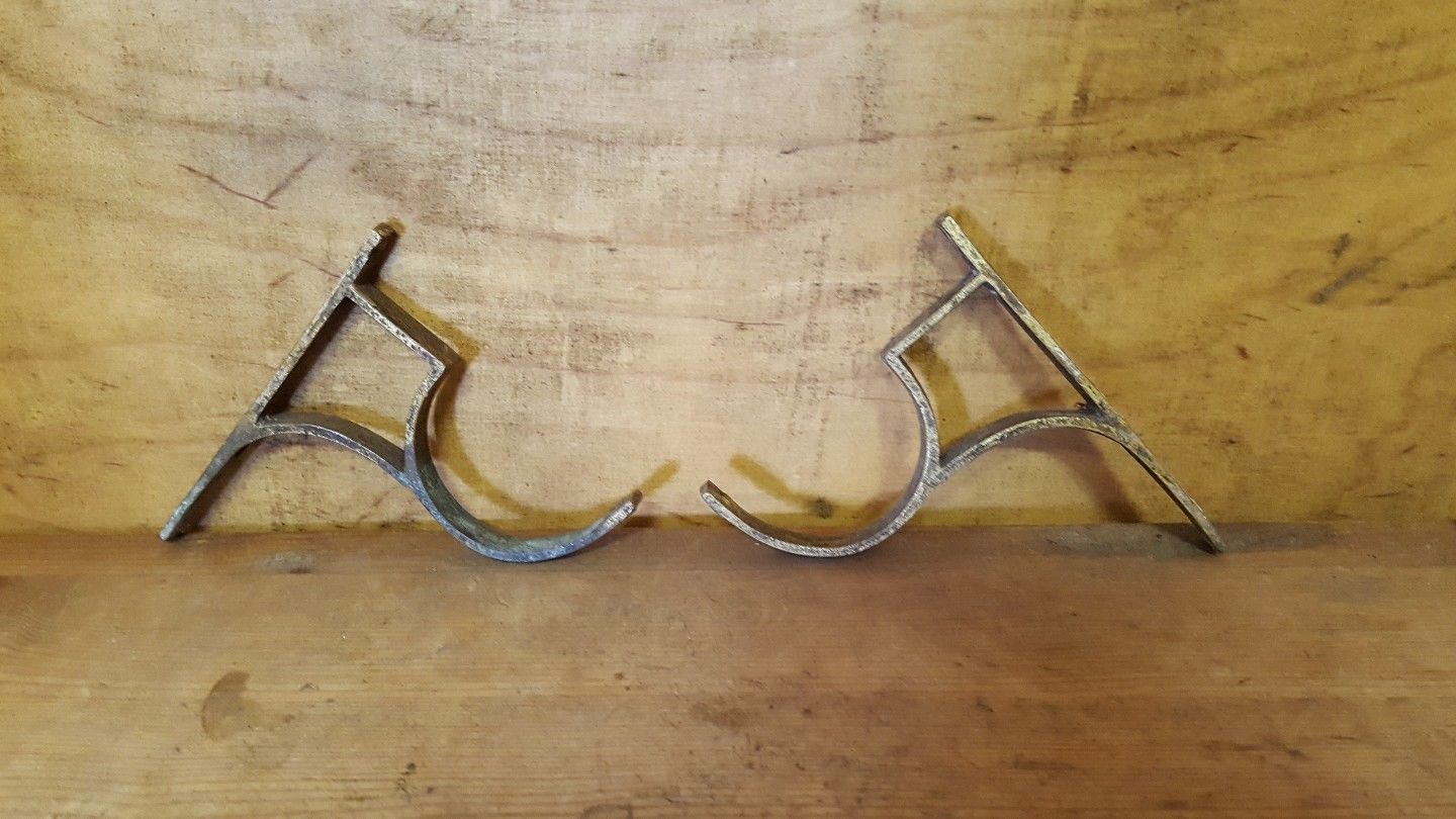 Antique pair of brass curtain pole brackets