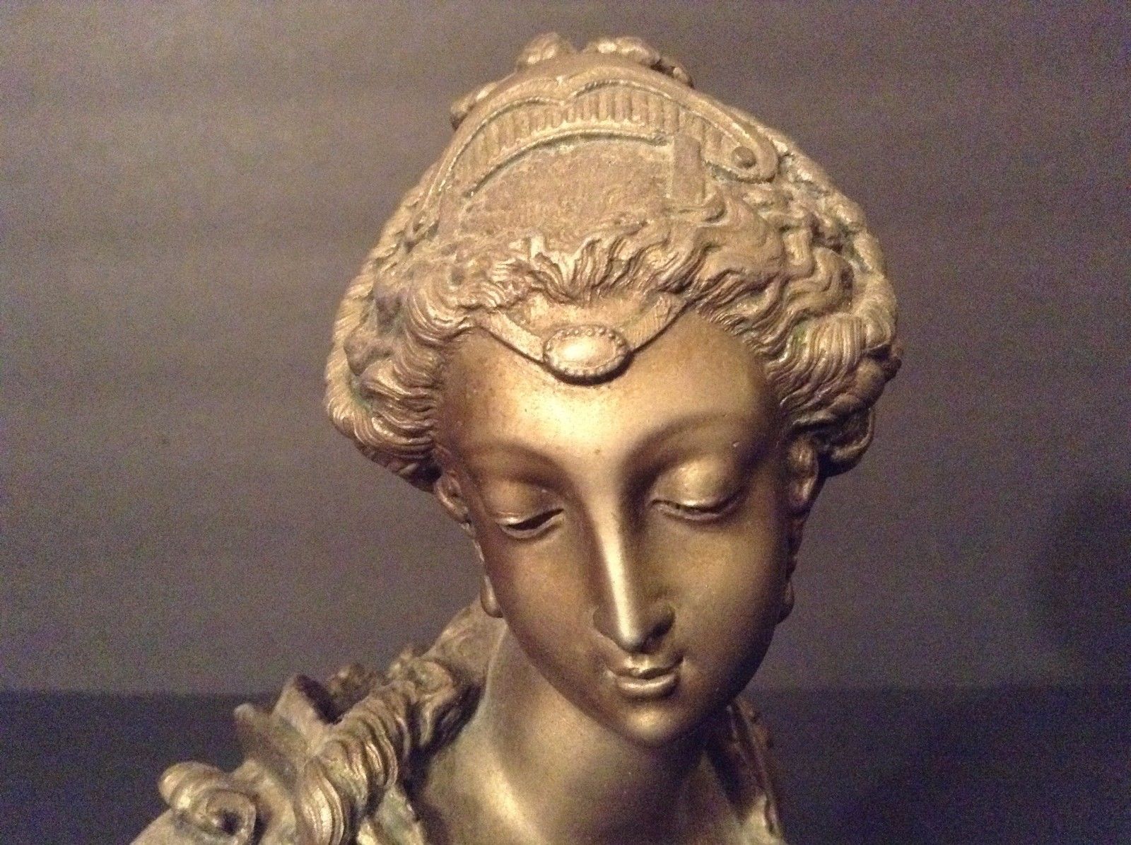 EUROPEAN BRONZE/ BRONZE-LIKE BUST OF A YOUNG WOMAN.