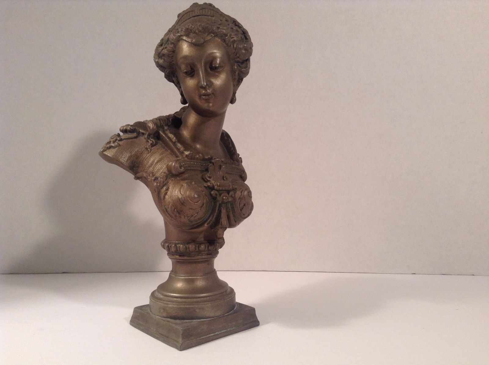 EUROPEAN BRONZE/ BRONZE-LIKE BUST OF A YOUNG WOMAN.