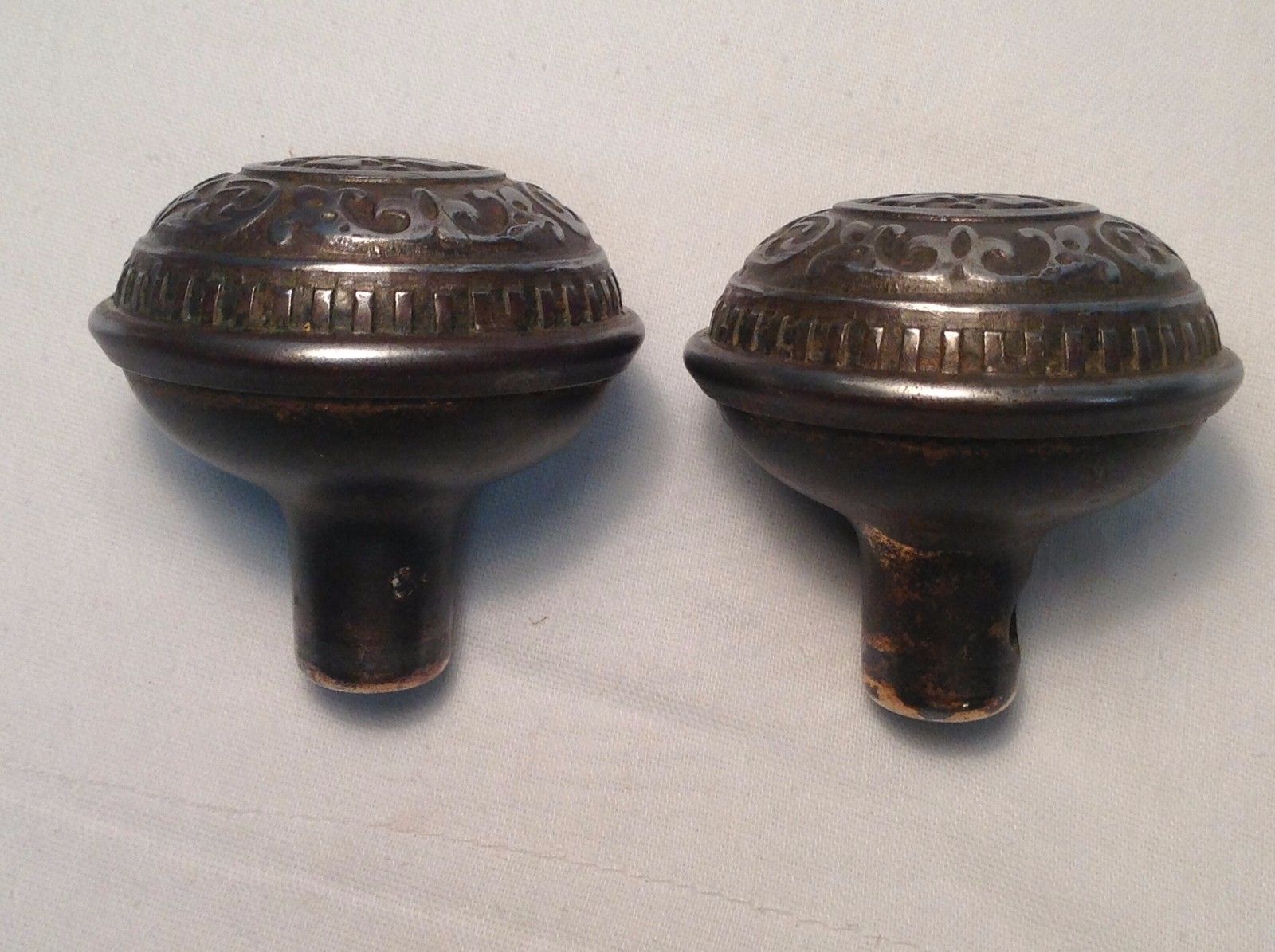 SET OF ANTIQUE ORNATE STEEL OR TIN DOOR KNOBS-WITH SPINDLE