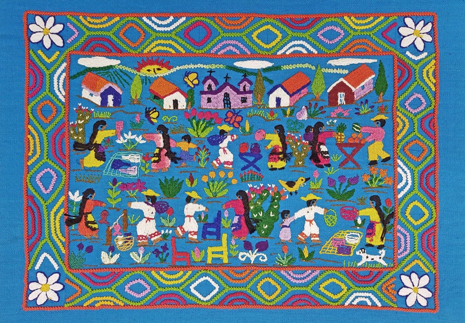 Mexican embroidery depicting village scene