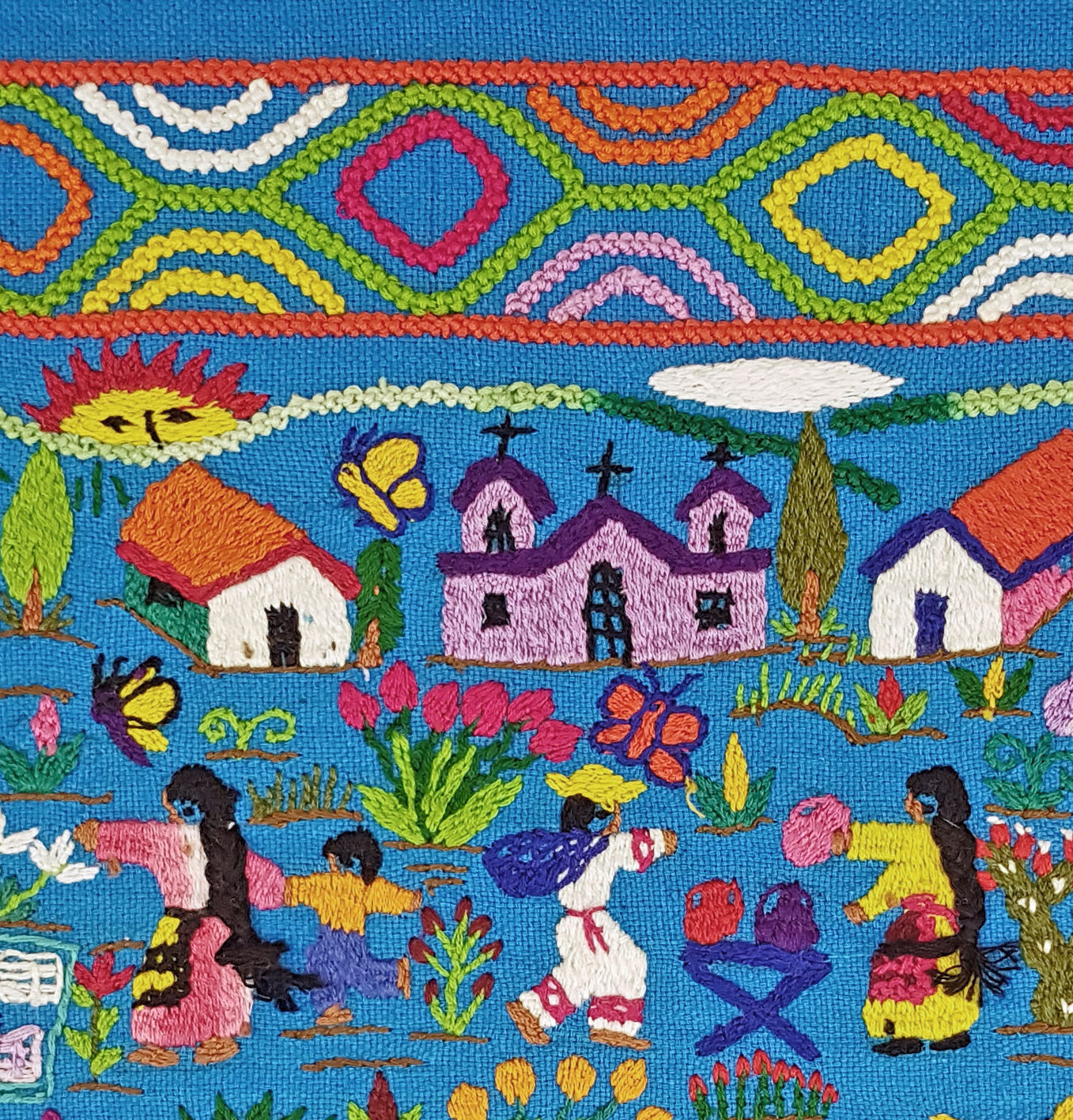 Mexican embroidery depicting village scene