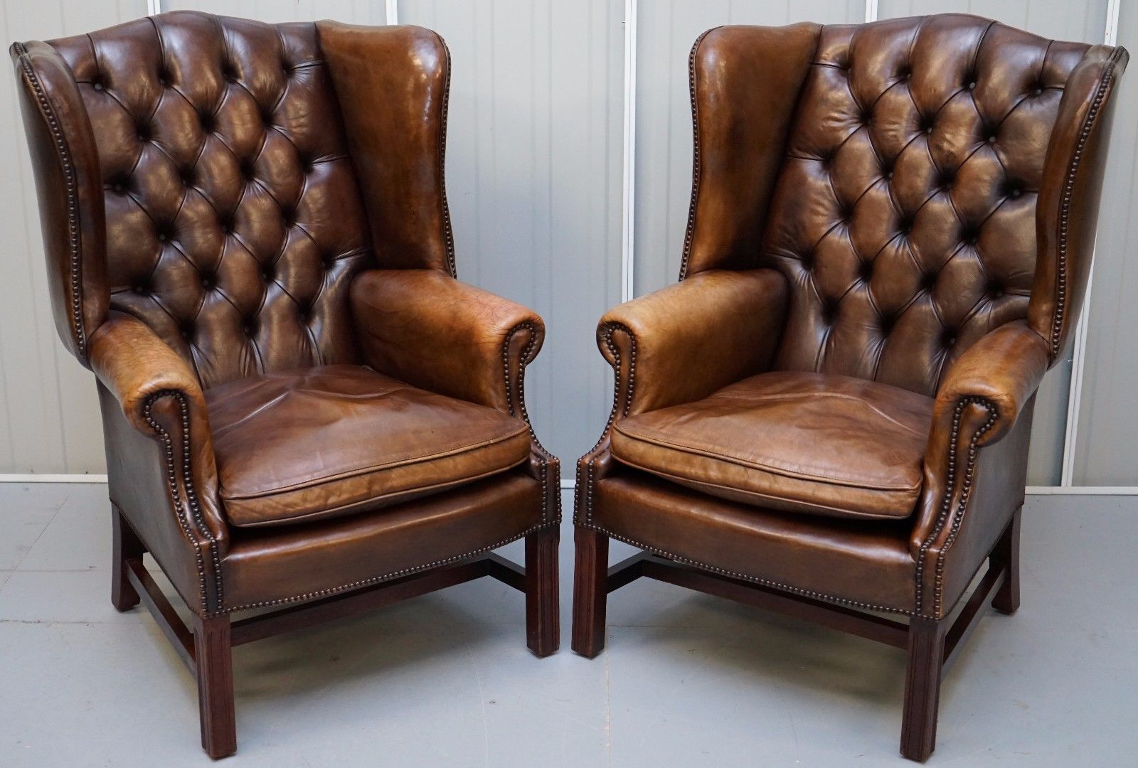 PAIR OF CHESTERFIELD VINTAGE BROWN LEATHER GEORGIAN STYLE WINGBACK ARMCHAIRS