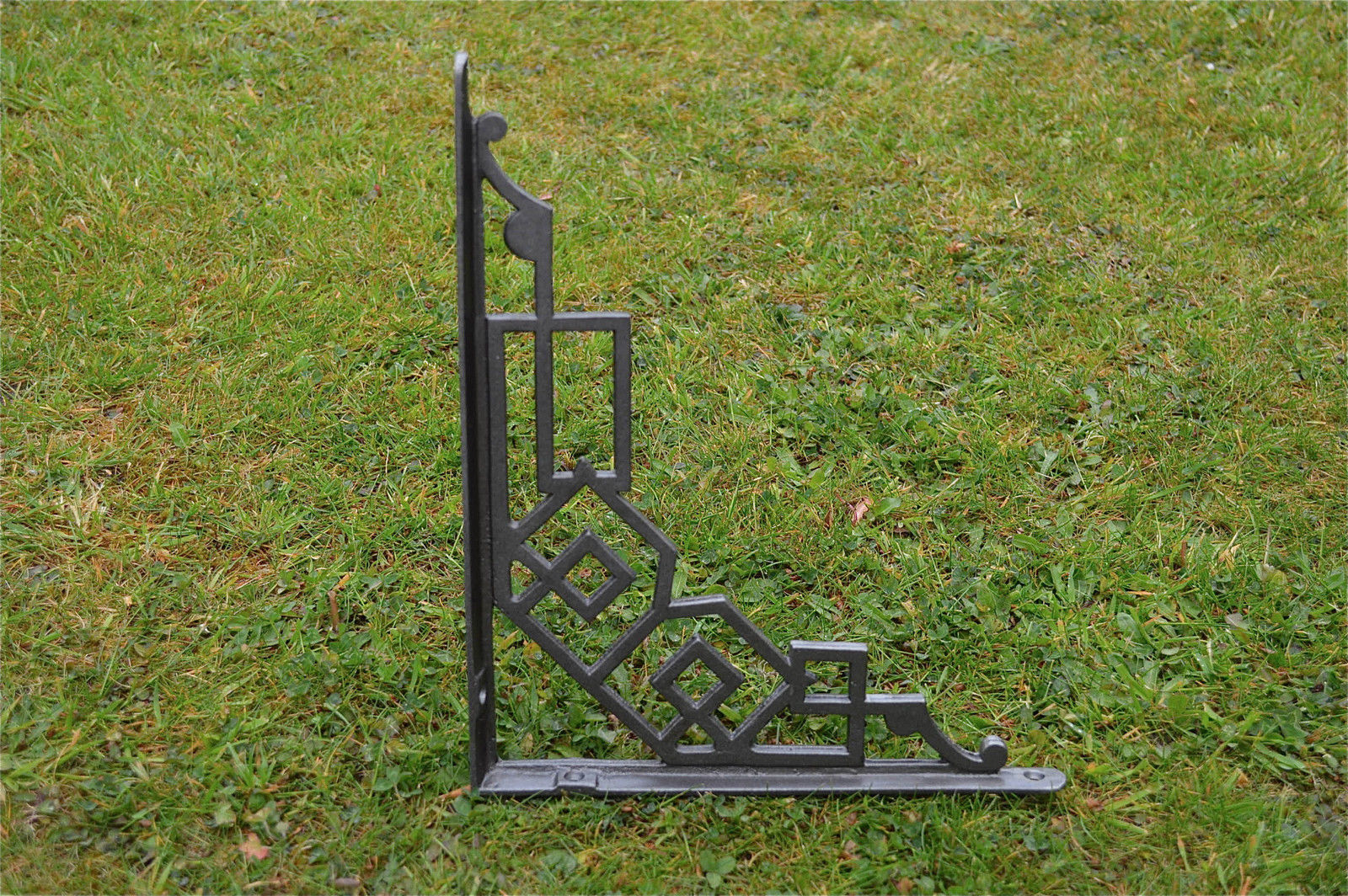 A pair of large cast iron Art Deco shelf brackets geometric design bracket