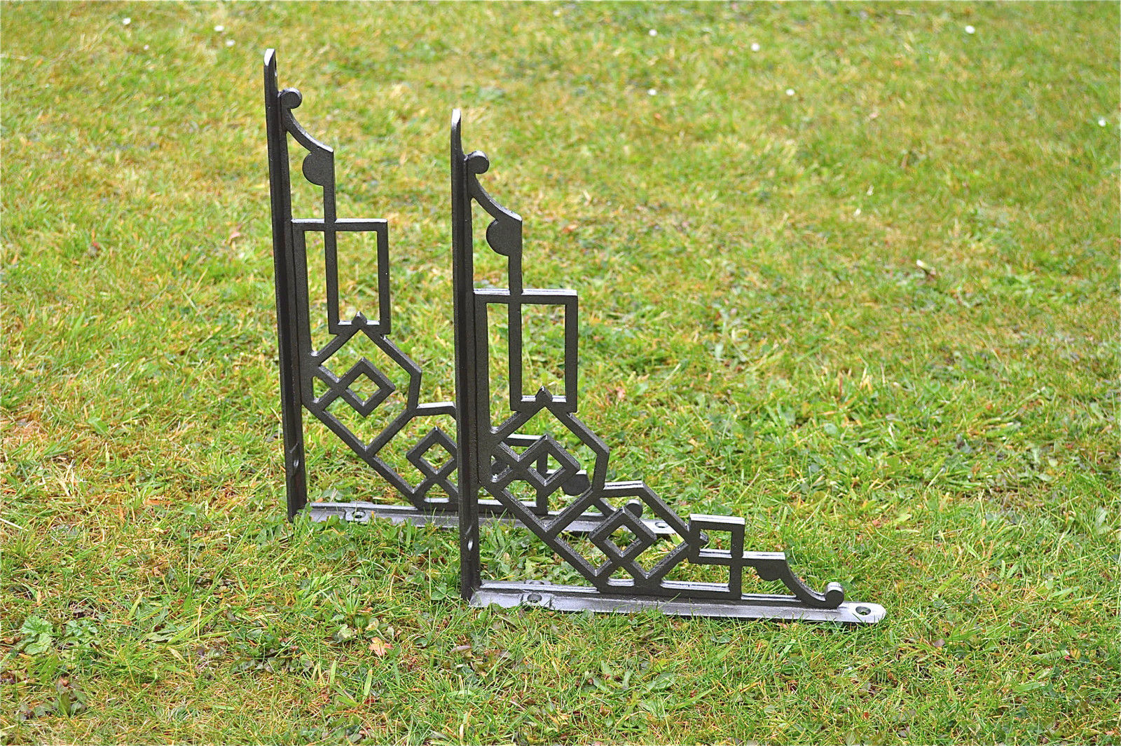 A pair of large cast iron Art Deco shelf brackets geometric design bracket