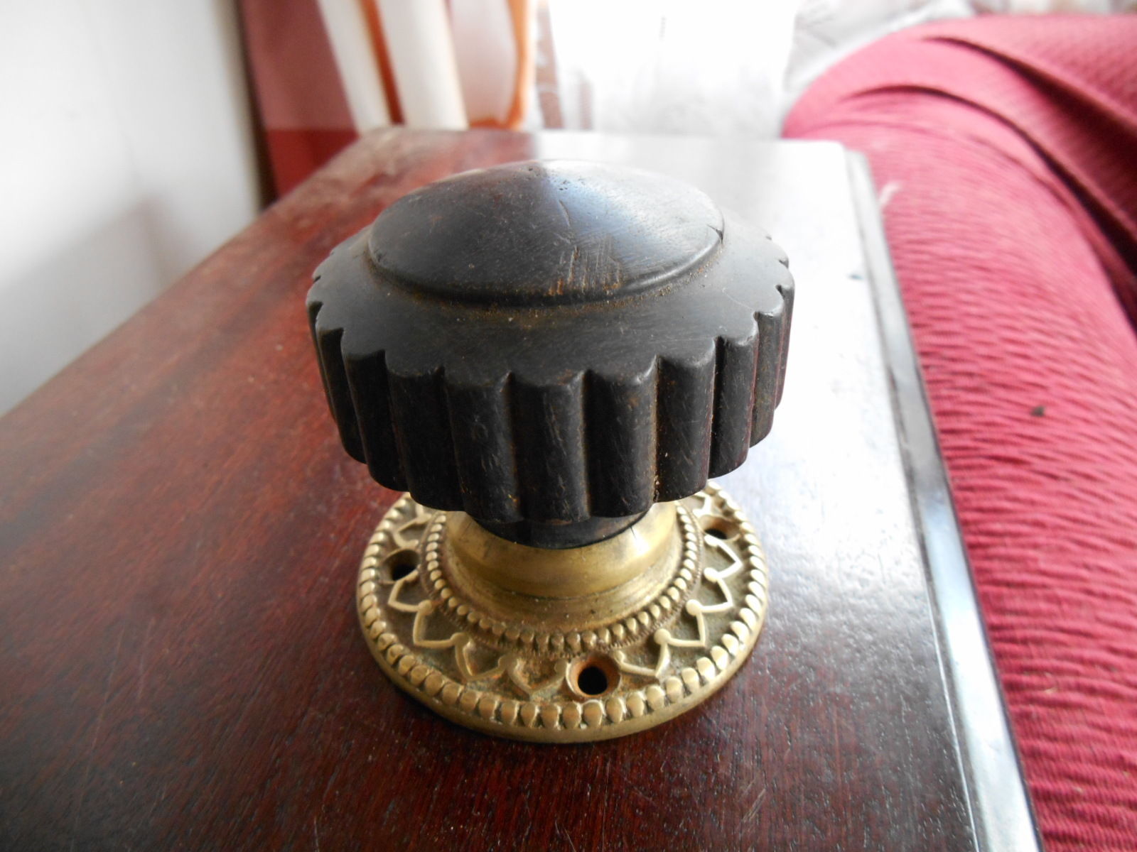 ANTIQUE EBONISED WOOD AND ORNATE CAST BRASS SINGLE DOOR KNOB AND FLANGE