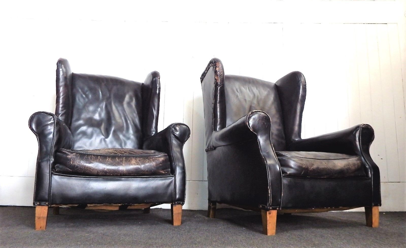 A Pair of Antique vintage black wing back arm chairs - armchairs