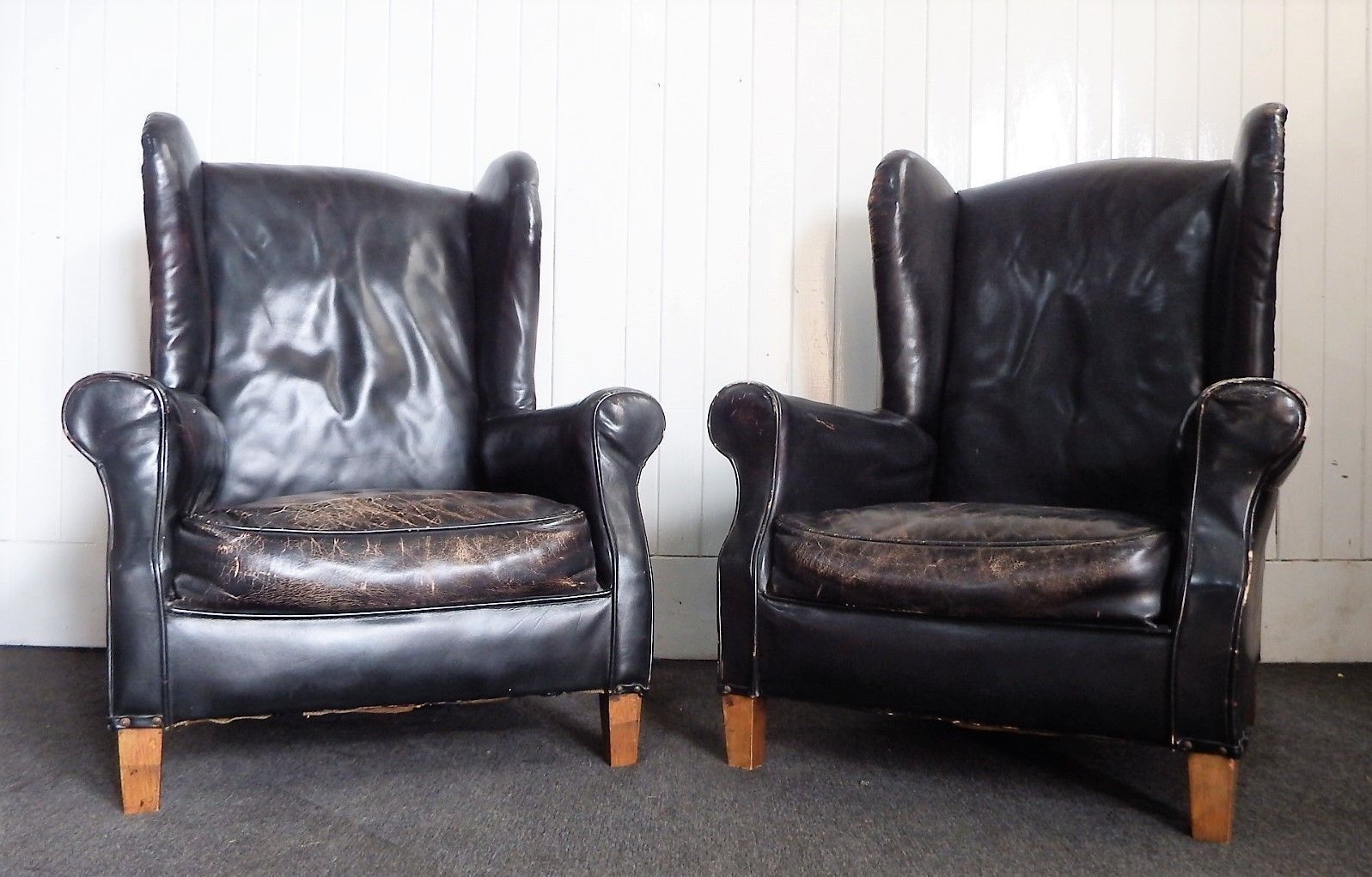 A Pair of Antique vintage black wing back arm chairs - armchairs