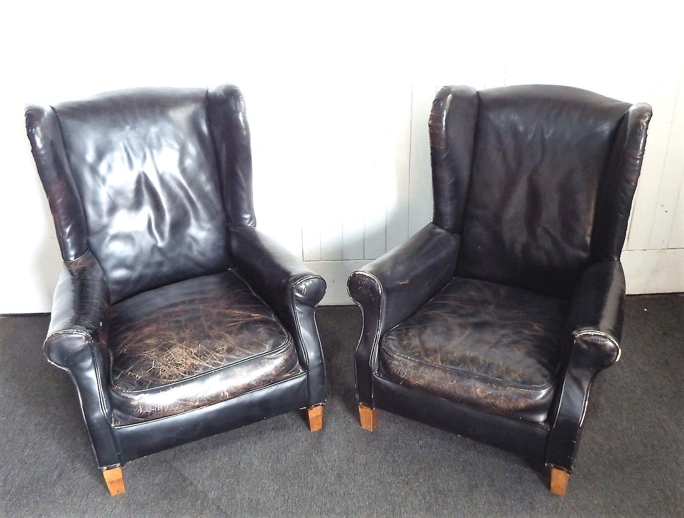 A Pair of Antique vintage black wing back arm chairs - armchairs