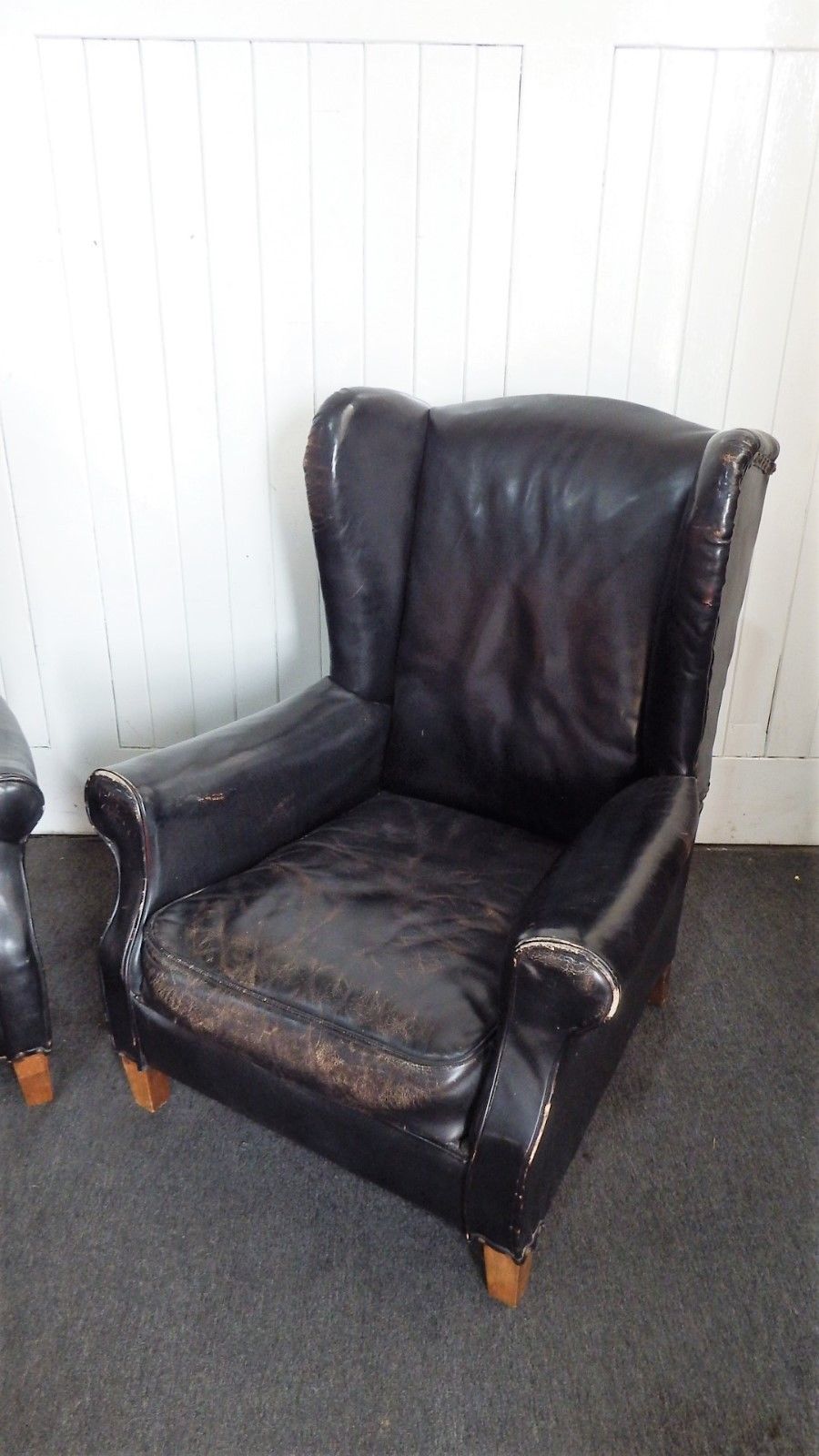 A Pair of Antique vintage black wing back arm chairs - armchairs